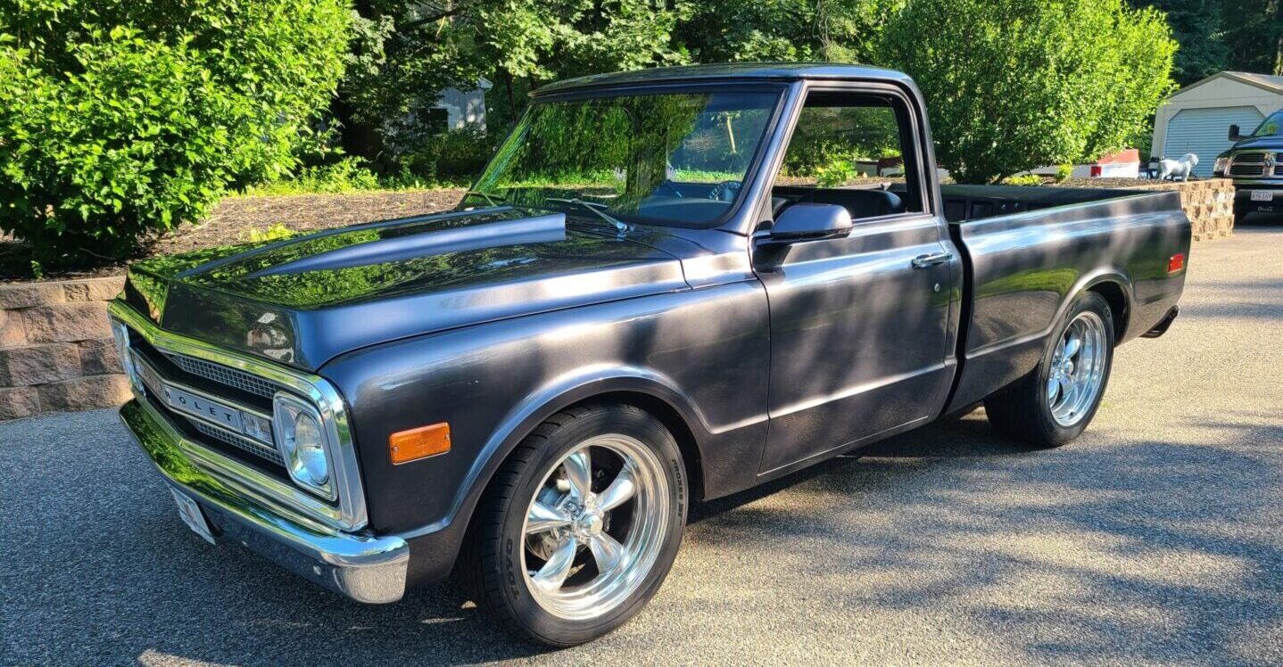 A truck parked in the driveway of a house.