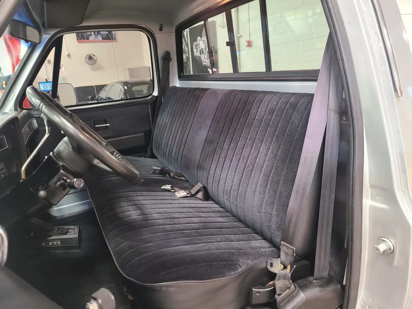 A truck with black seats and a steering wheel.