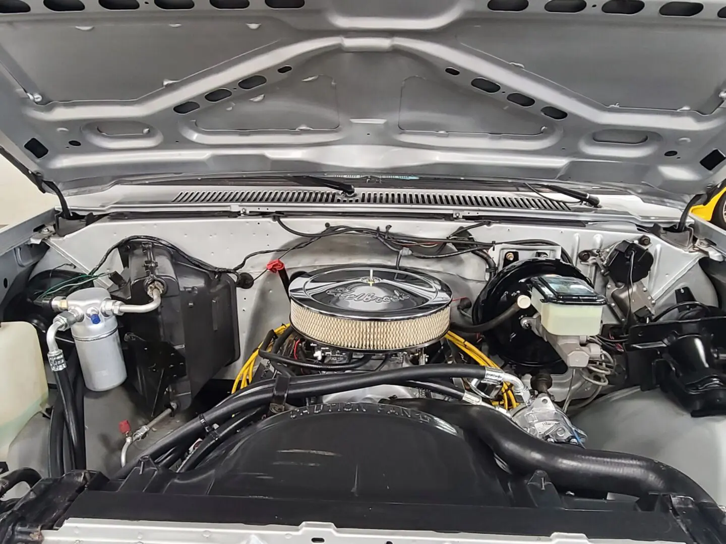 A car engine with the hood open.