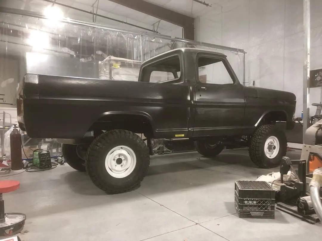 A black truck is parked in the garage.