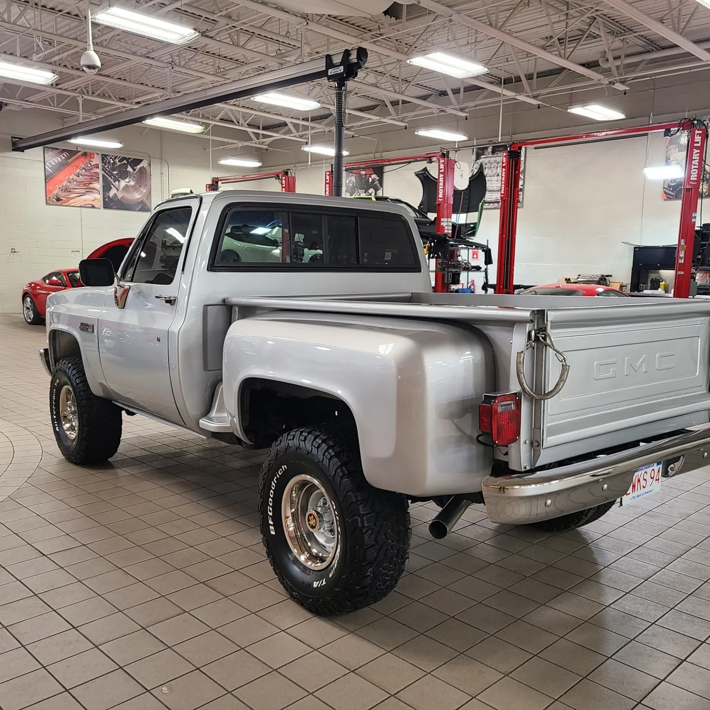 A truck is parked in the middle of a showroom.